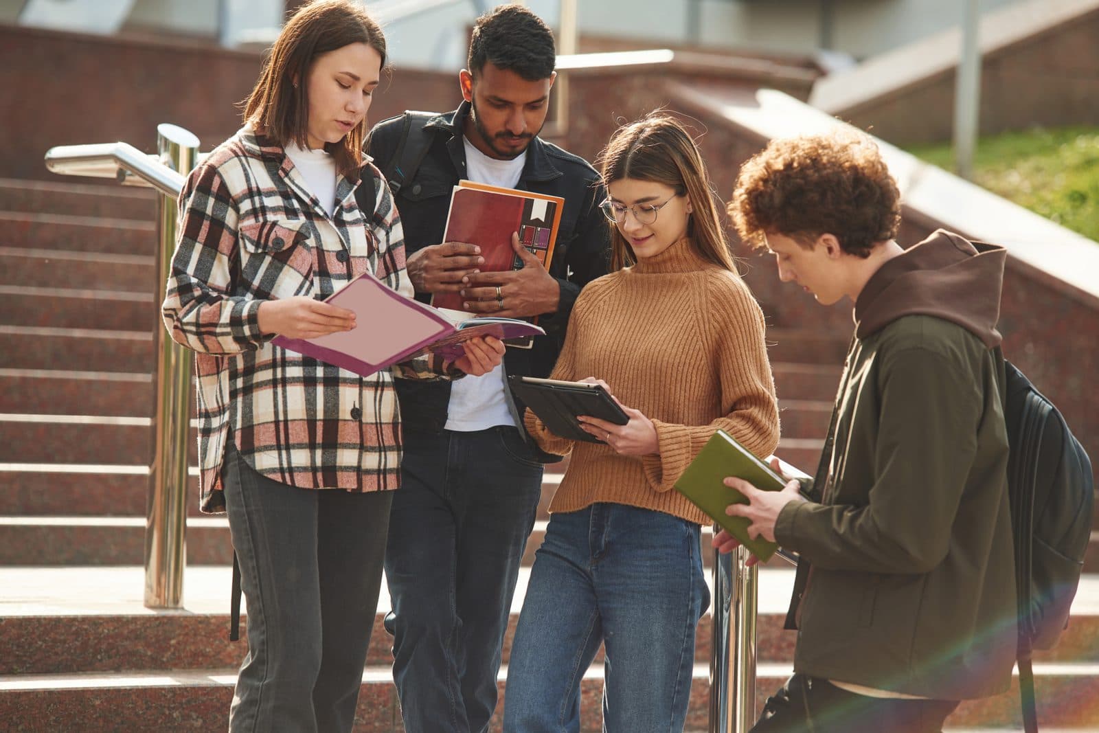 Students studying together on campus steps